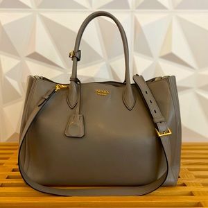 Prada handbag, grey accordion style with white side stripe. Crossbody strap.